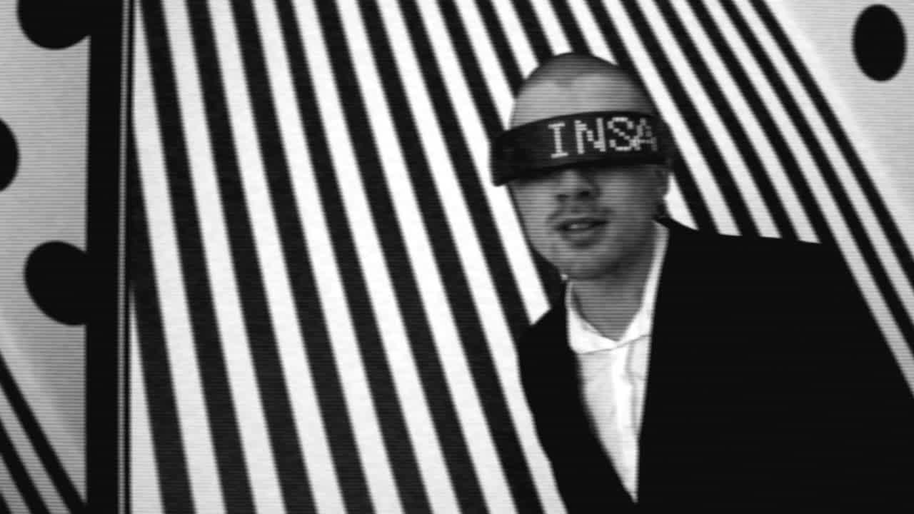 Man with LED headband in black and white striped background