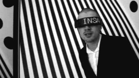 man with led headband in black and white striped background