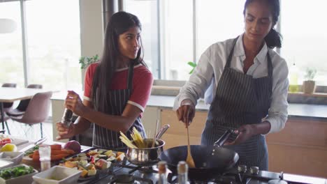 Video-of-happy-diverse-female-friends-preparing-meal