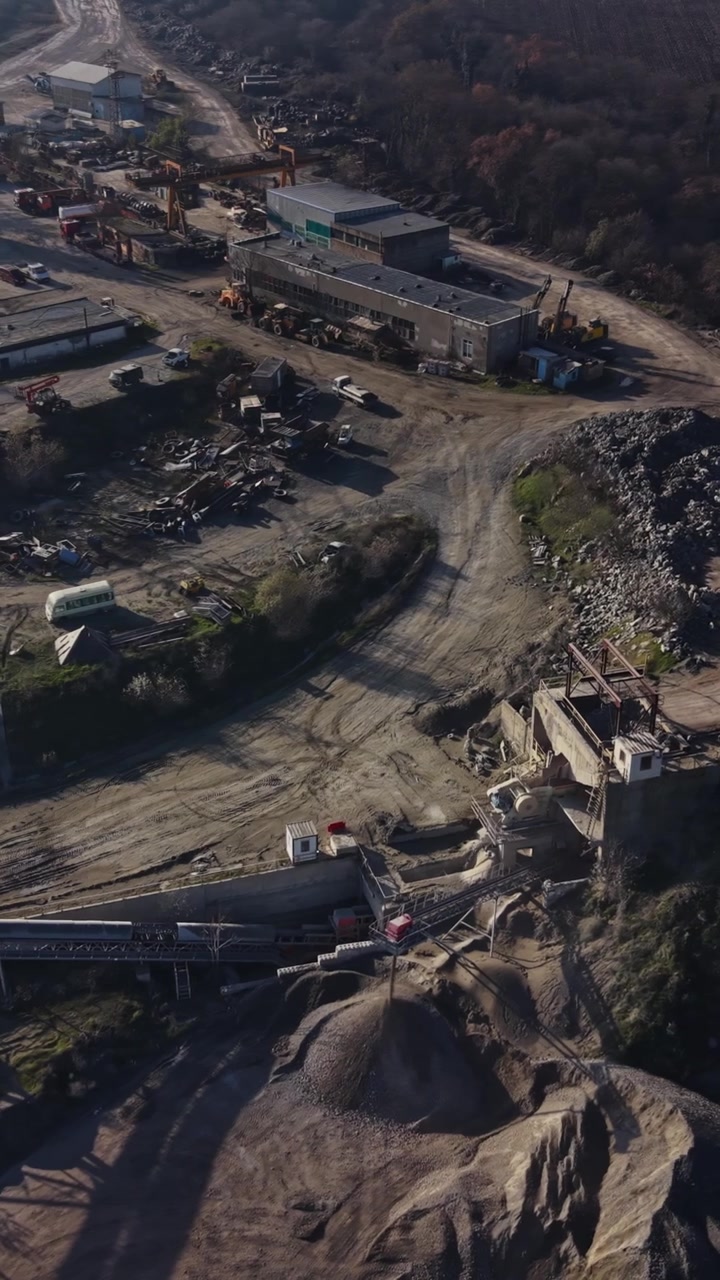 Quarry site shows heavy machinery and mining equipment at work