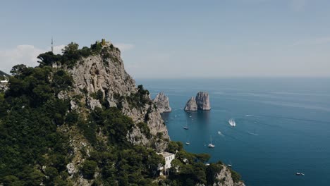 aerial view orbiting around capri, italy's marina grande mountain top