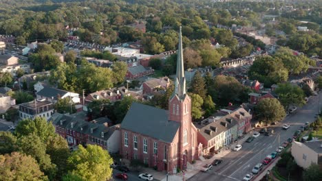 Aerial-of-large-brick-church-and-steeple-in-American-urban-city-community