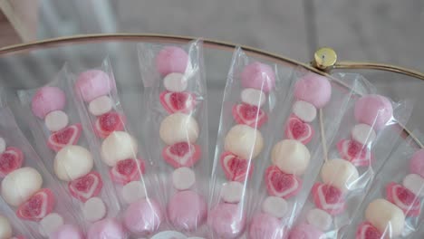 colorful skewers with heart candy and marshmallows wrapped for a wedding treat