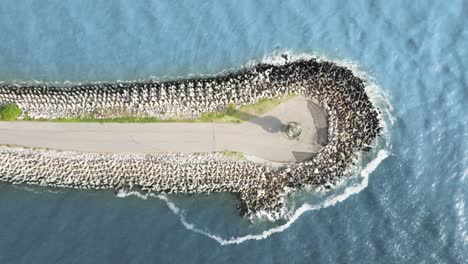 Aerial-top-view-approaching-the-lighthouse-of-Farol-Do-Molhe-Da-Barra-De-ItajaÃ­,-Santa-Catarina,-Brazil