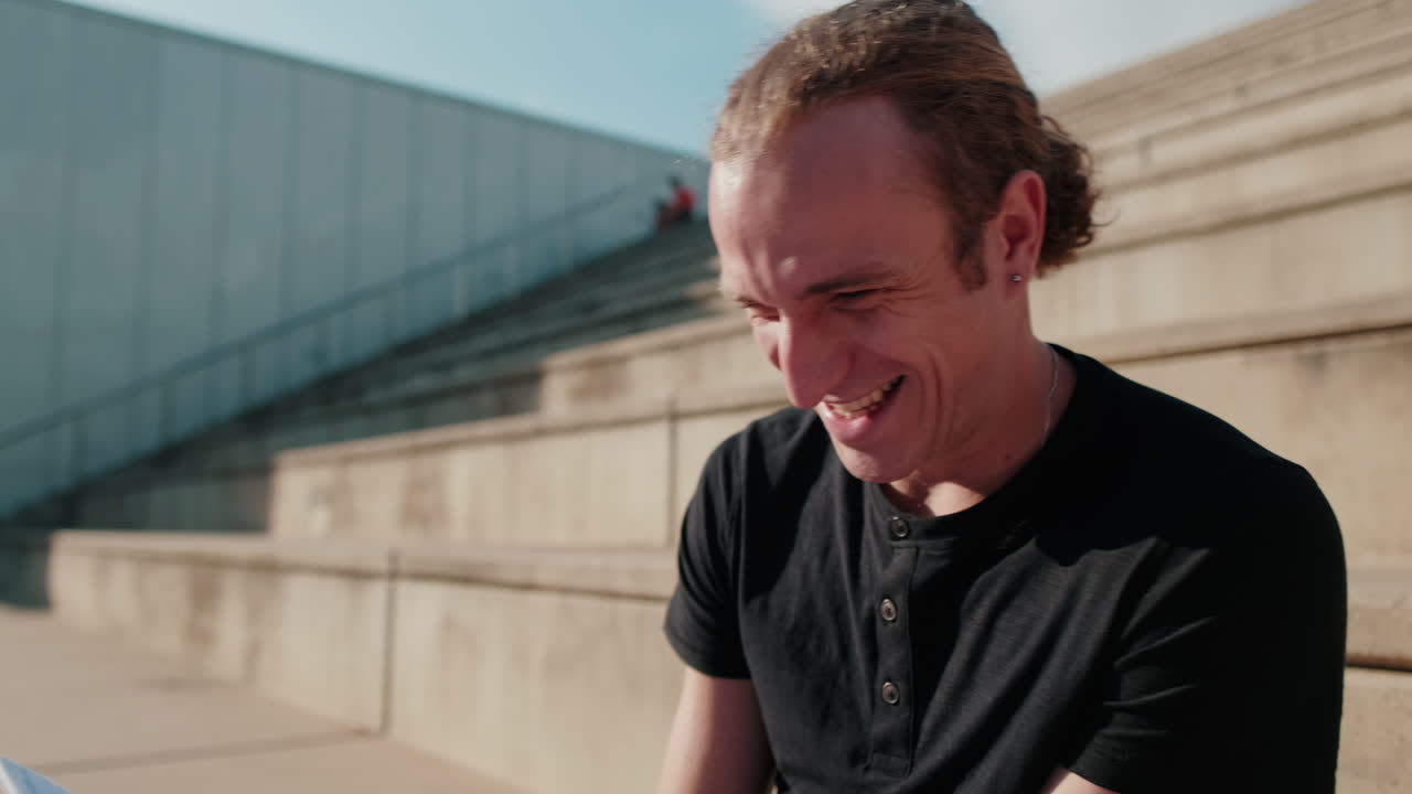 Portrait of a carefree student guy talking to friends. Cheerful young boy