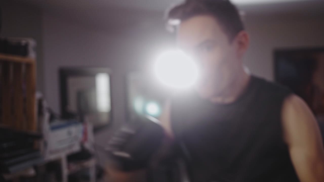 Athletic Man Punching Vertical Boxing Ball At Home