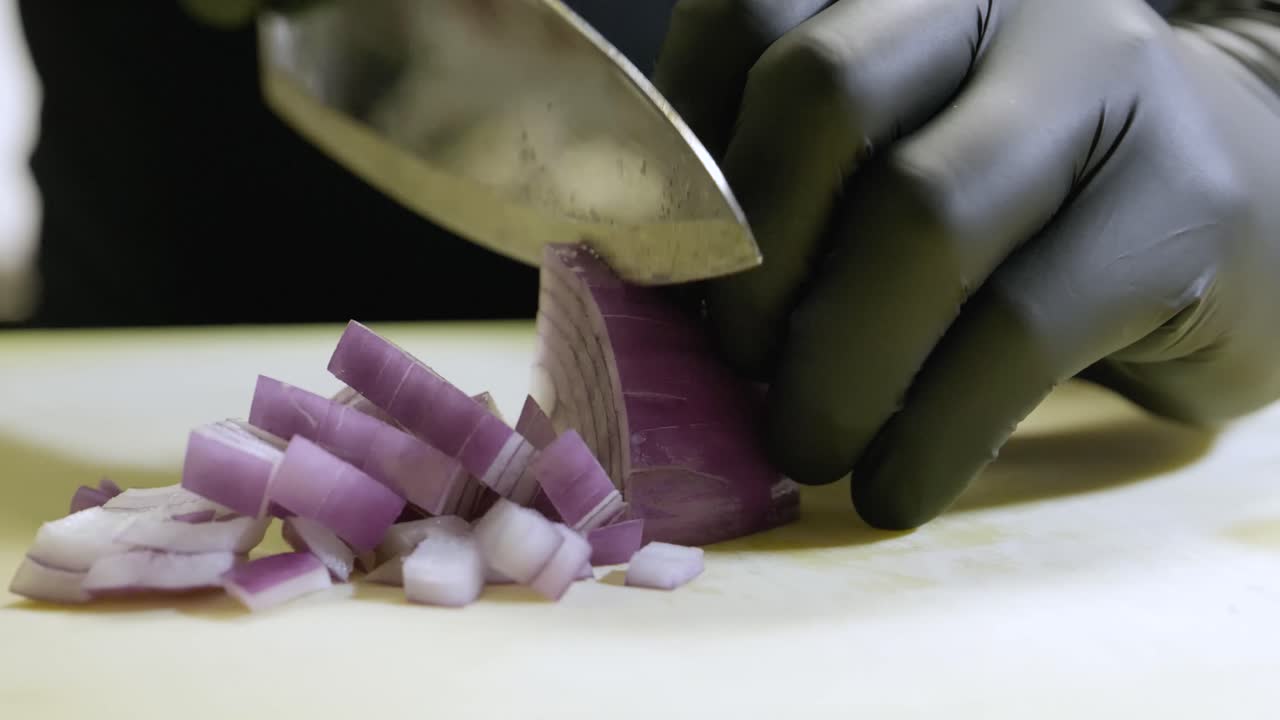 Cook chops red onion into small squares.