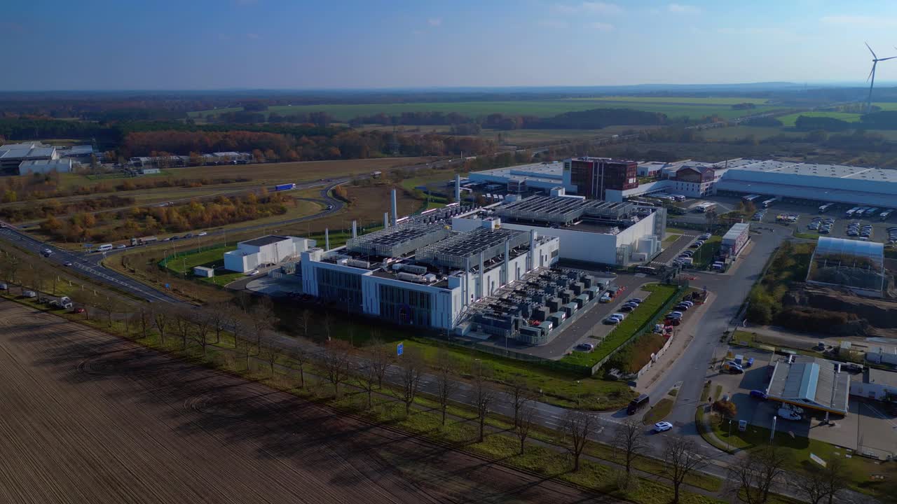 Modern big data center facility standing in an industrial area, serving digital information and connectivity. Smooth aerial view flight static tripod hovering drone