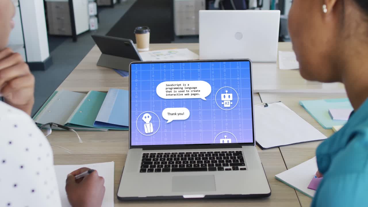 Diverse businesswomen using laptop with data processing on screen in office
