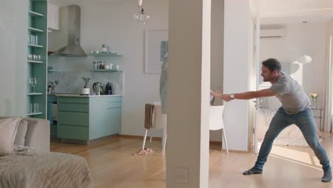 happy young couple dancing at home enjoying dance together having fun celebrating relationship