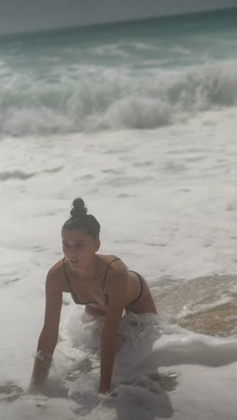 woman playing in the waves on the beach