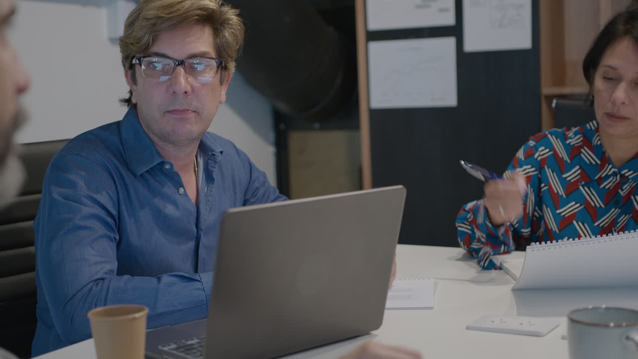 Mature Business Lady Having Meeting with Male Associates