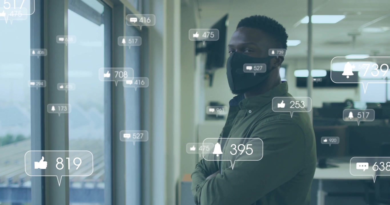 Masked office worker standing by window, alert bubble floating and showing business data near him