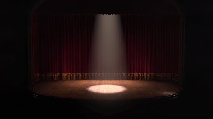 Riflettore che Illumina un Palco Teatrale Vuoto