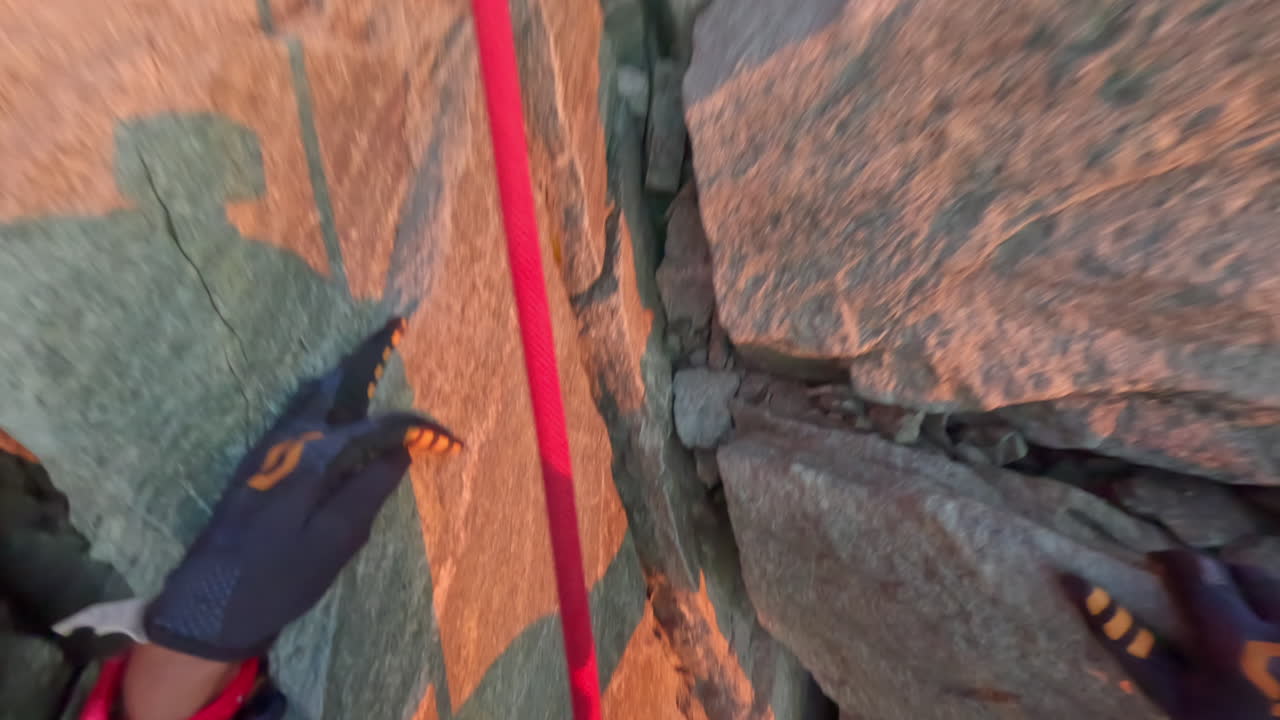 First-person POV of a climber ascending the iconic Matterhorn at sunrise on a crystal-clear bluebird day. Captured on GoPro for an immersive, realistic mountaineering experience above the clouds
