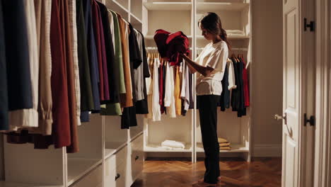 woman choosing clothes in a stylish closet