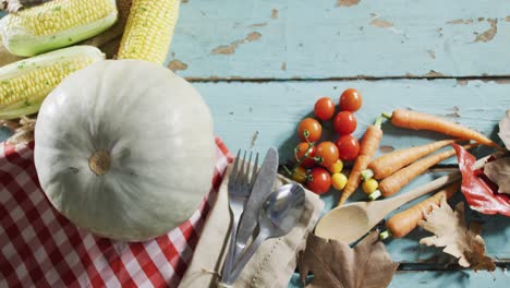 close up view of pumpkin, multiple food ingredients and cutlery on wooden surface