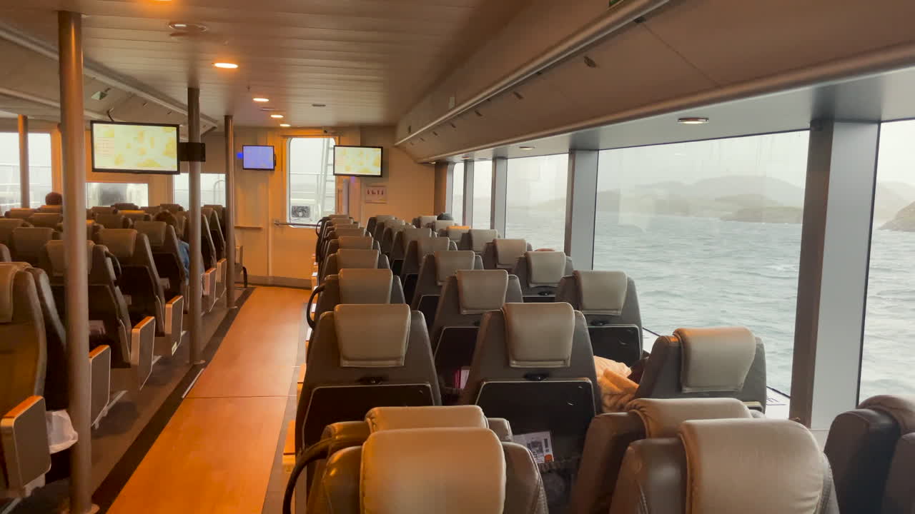 Panning shot of a lounge inside a high speed passenger boat in Norway
