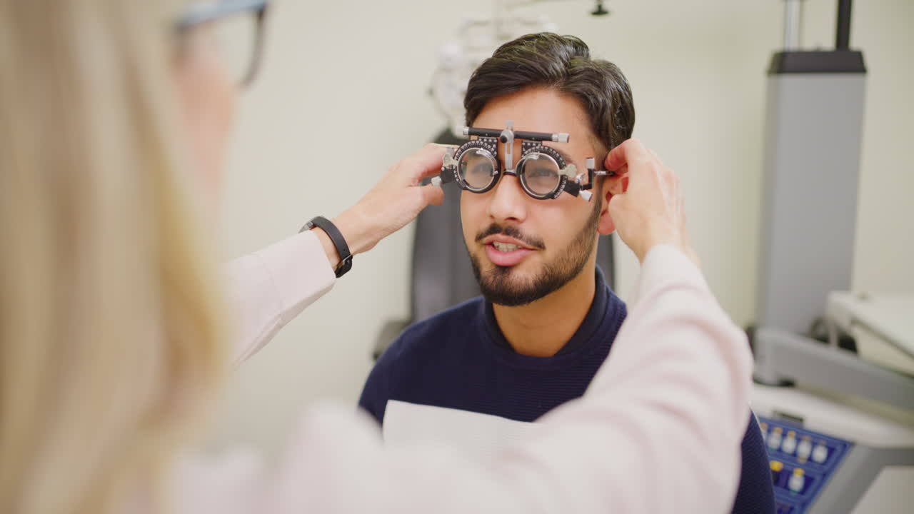 Optometrist giving male patient an eye test