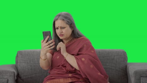 Indian-old-woman-scrolling-through-phone-Green-screen