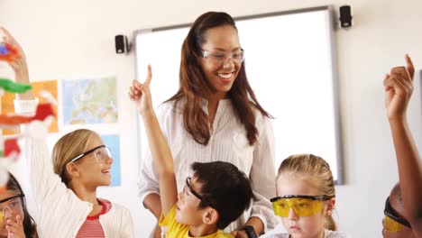 school kids doing a chemical experiment in laboratory