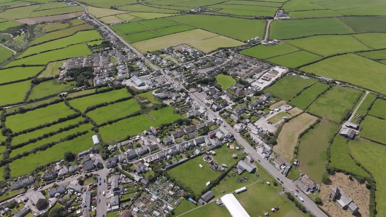 Aerial view of Delabole, a large village in North Cornwall, showcasing rural residential areas, green fields, and the surrounding countryside, Cornwall, UK