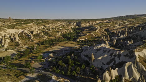 Göreme-Turkey-Aerial-v26-cinematic-flyover-love-valley-capturing-spectacular-unique-shape-fairy-chimneys,-nature-rock-formations-caused-by-volcanic-eruption---Shot-with-Mavic-3-Cine---July-2022