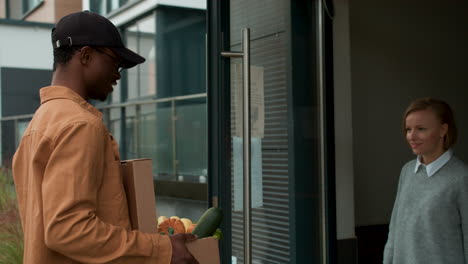 Courier-delivering-box-of-vegetables