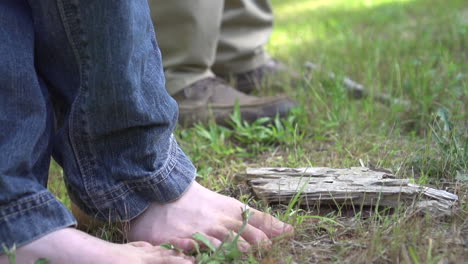 father and son fishing, son is barefooted