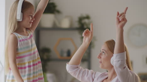 mother and daughter dancing with headphones