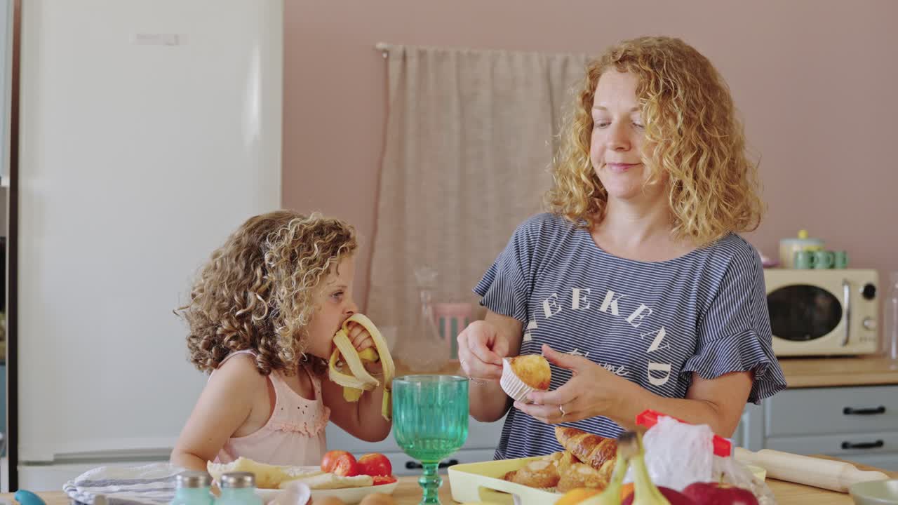 Mother and Daughter Baking Cupcakes in the Kitchen