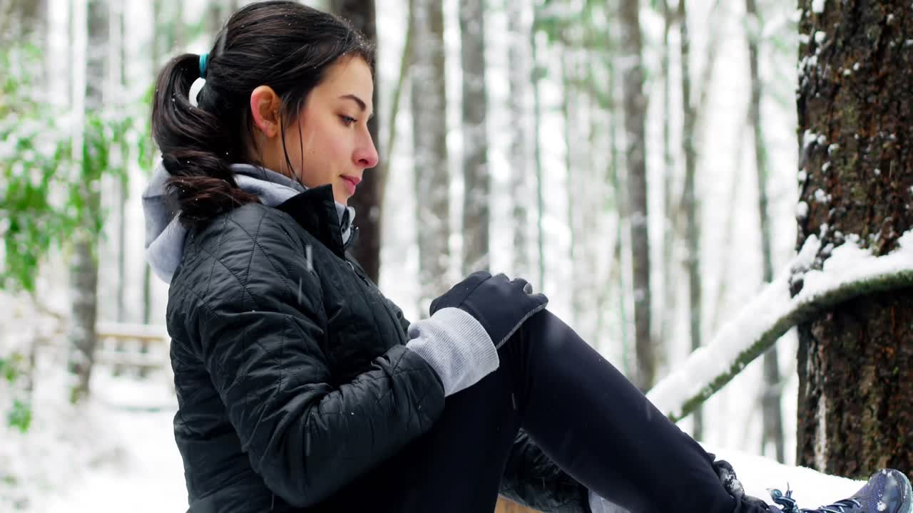 Beautiful woman exercising during snowfall