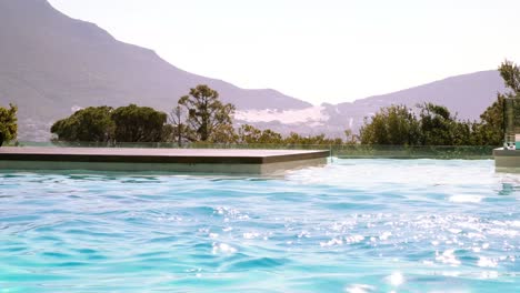 fit swimmer doing butterfly stroke in outdoor pool