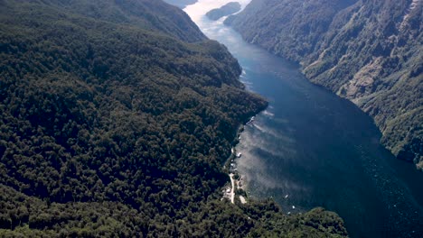 aerial tilt up showing long journey in new zealand fjord