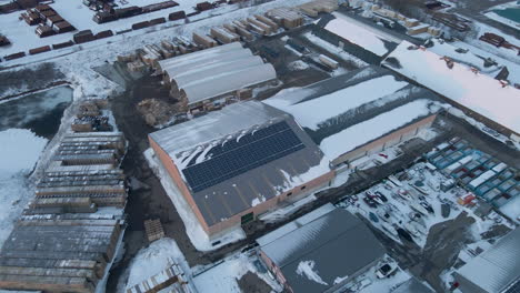 Aerial-of-solar-panels-on-industrial-warehouse-in-winter