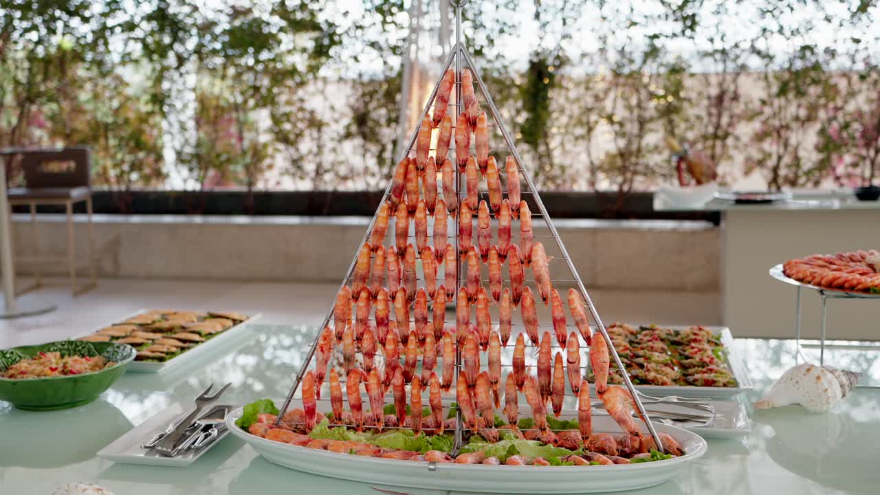 Shrimp pyramid centerpiece at seafood buffet during formal event