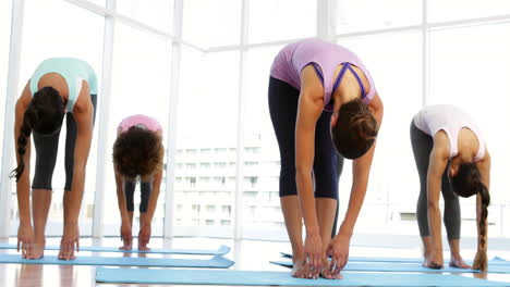 Yoga-class-warming-up-in-fitness-studio