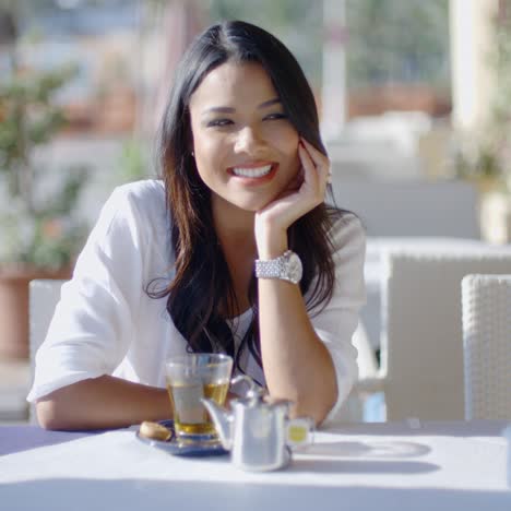 Girl-Sitting-At-Cafe-With-Cup-Of-Tea