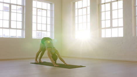 healthy-yoga-woman-practicing-downward-facing-dog-pose-enjoying-fitness-lifestyle-exercising-in-workout-studio-training-on-exercise-mat-at-sunrise