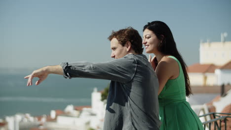 Multiracial-young-couple-enjoying-sea-view-on-vacation.