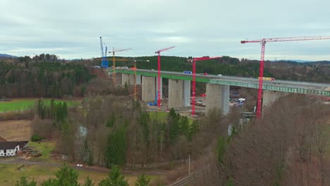 flying towards bridgeworks with industrial cranes