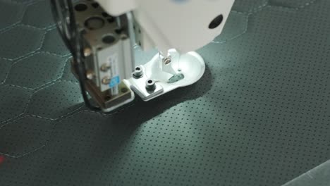 closeup of sewing machine working part with leather. cnc sewing machine