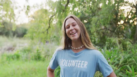 Caucasian-woman-smiling-and-looking-at-camera-during-river-clean-up-day