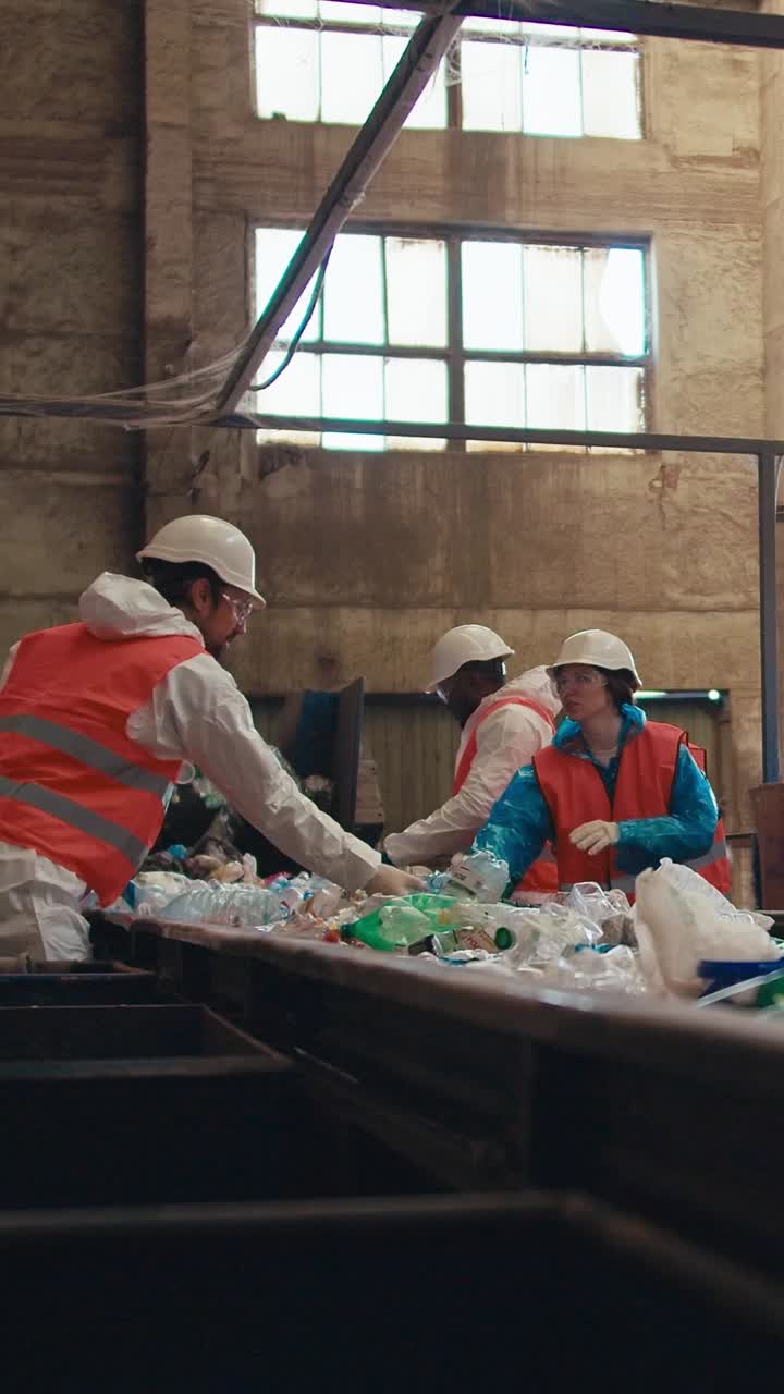 Recycling Facility Workers Sorting Waste