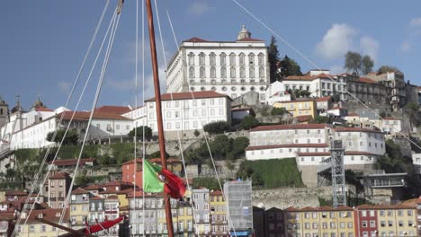 the iconic rabelo boats which are the traditional port wine transports with portugal flag