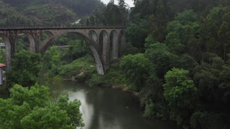 aerial revealing stone bridge over vouga river, sever do vouga portugal