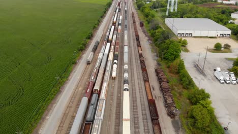 4k aerial view showing multiple trains parked at a train station waiting to leave