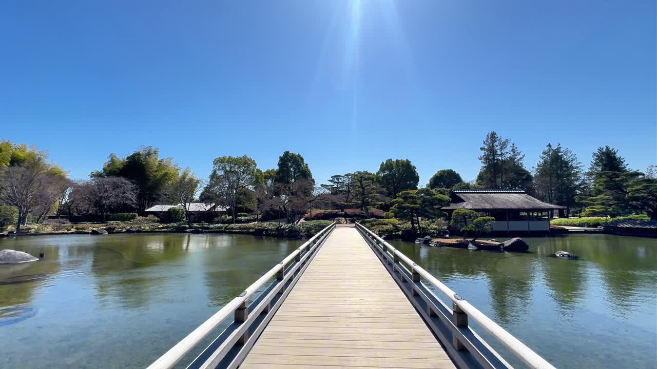 藍天白雲下寧靜的日式庭園景色與木橋