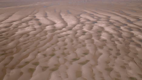 Rippled sands and seawater pools on tidal flats on a sunny day. Fleetwood, Lancashire, UK.