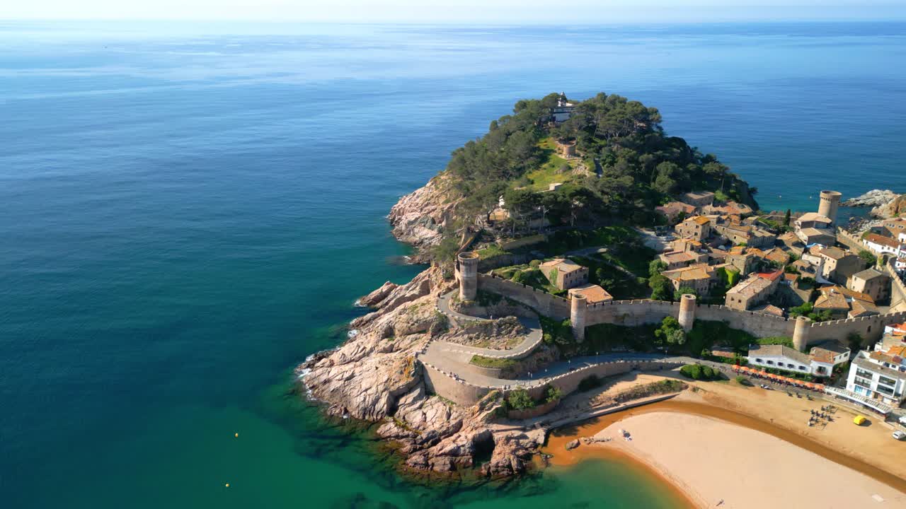 Breathtaking aerial view of tossa de mar, a charming coastal town nestled on the costa brava in catalonia, spain, showcasing its beautiful beach, historic castle, and whitewashed buildings